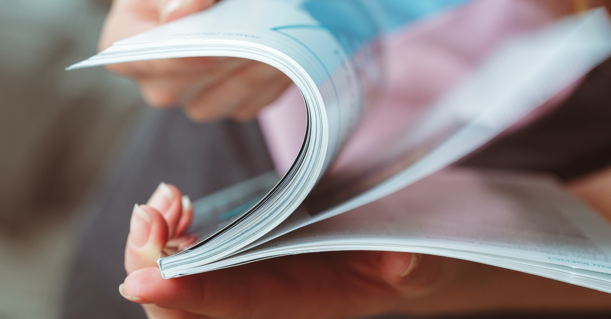 woman reading magazine at home