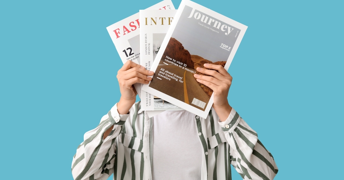 woman with magazines on blue background