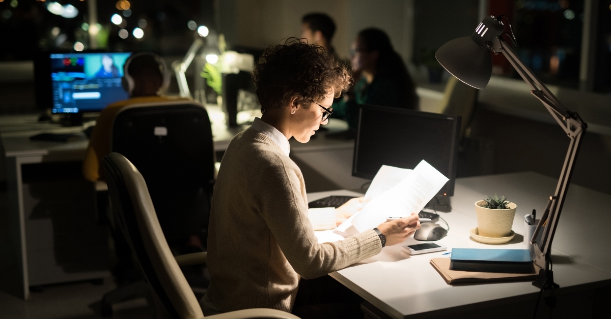 businesswoman working late in dark office