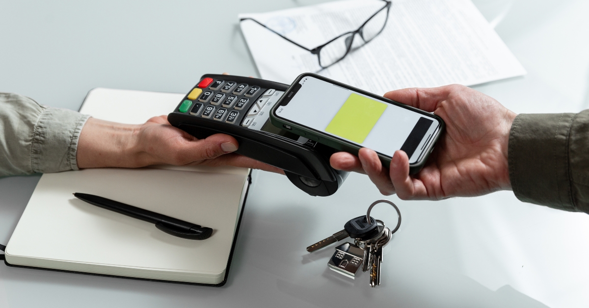 hands using pos terminal and smart phone to complete nfc payment 