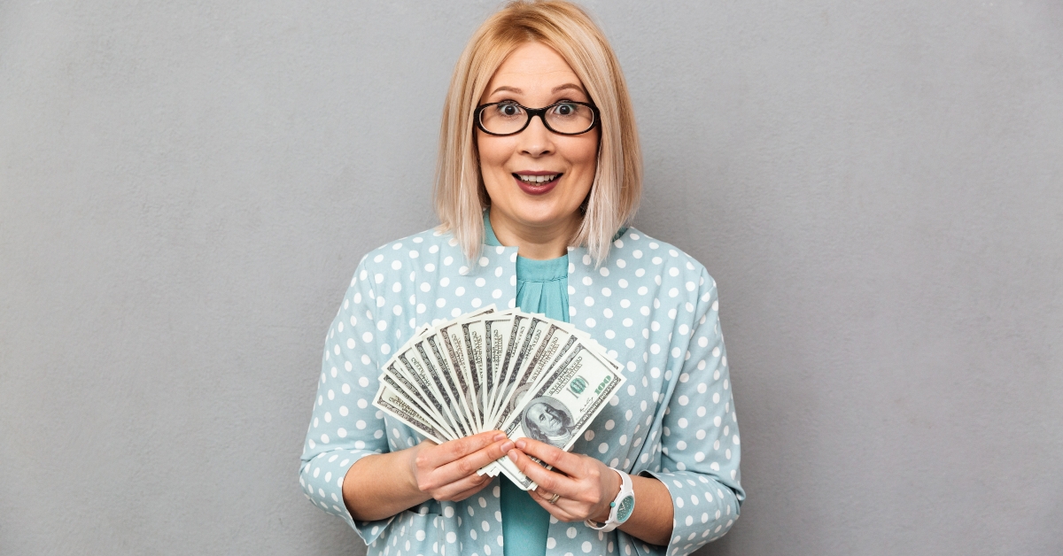 woman in eye glasses holding a money