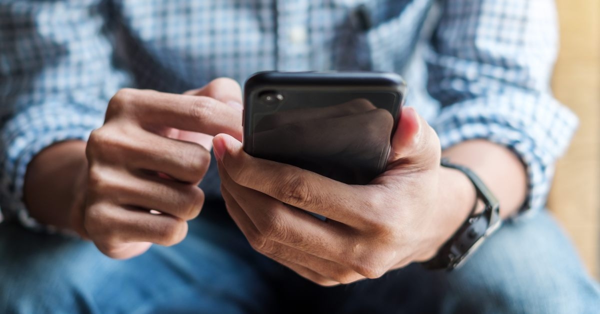 businessman holding and using smartphone