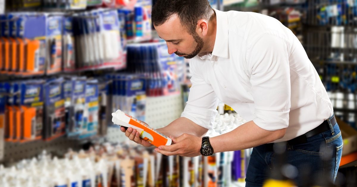 man choosing sealant tube