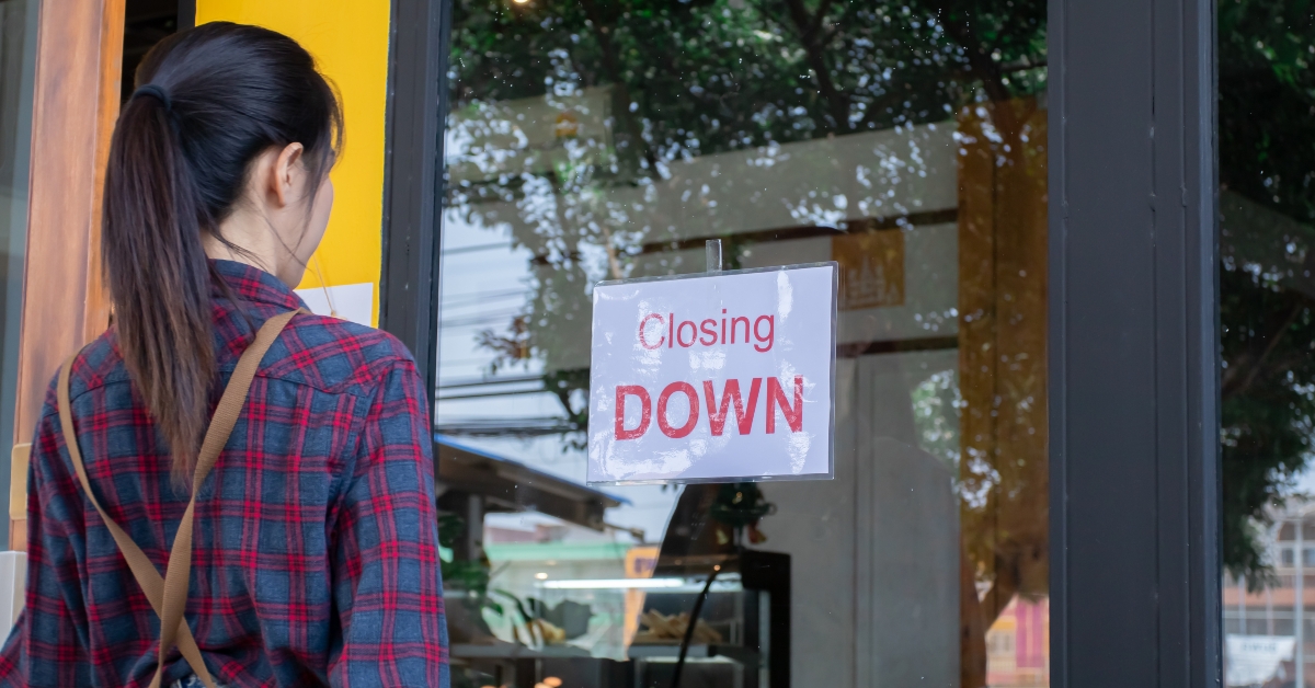 businesswoman stands infront of cafe