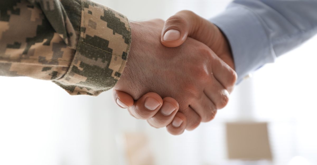 soldier and businessman shaking hands