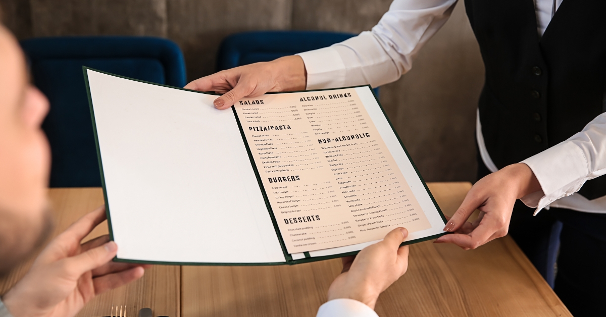 waitress showing man a menu
