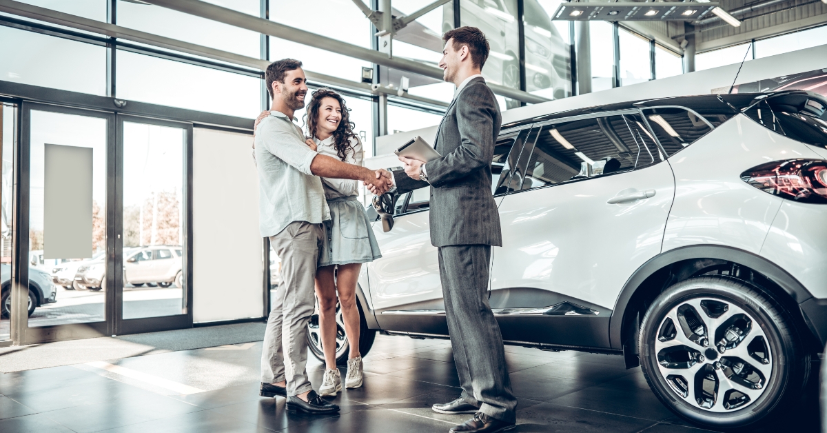 couple shaking hands with sales agent