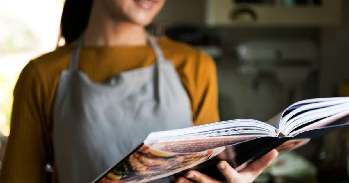 japanese woman reading a cookbook