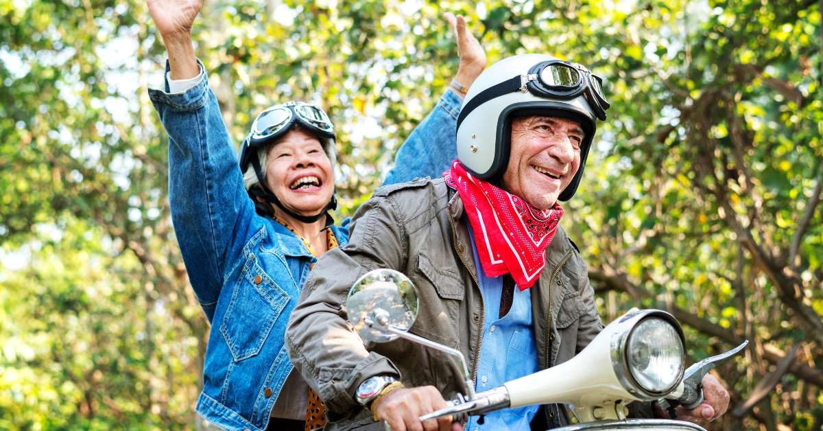 senior couple riding a classic scooter