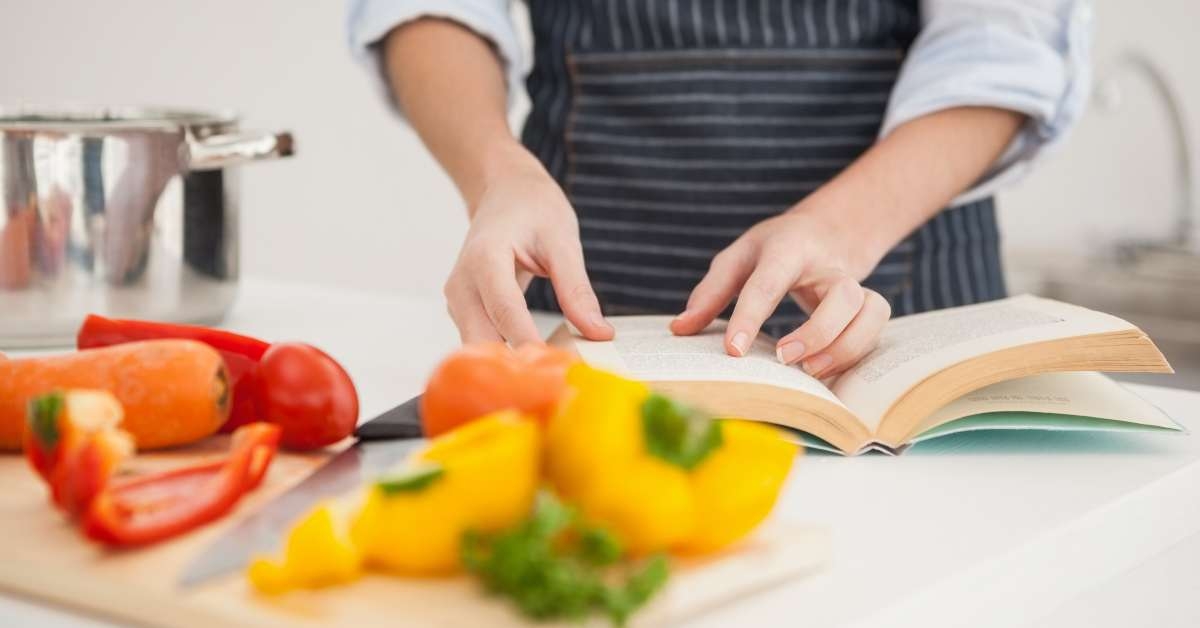 woman following a recipe in book