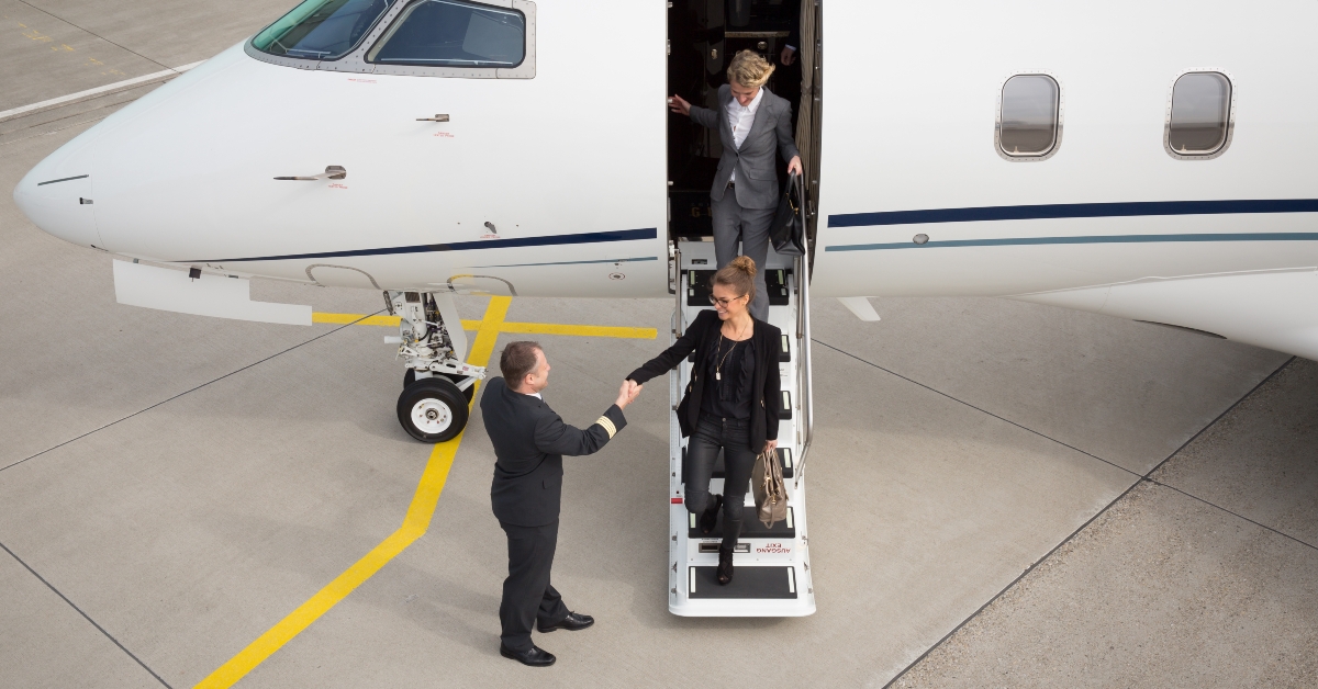An executive business woman leaving a plane