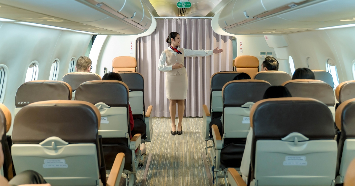 Flight attendant giving safety instructions to passengers