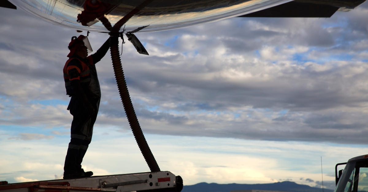 Airport staff operator refueling aircraft
