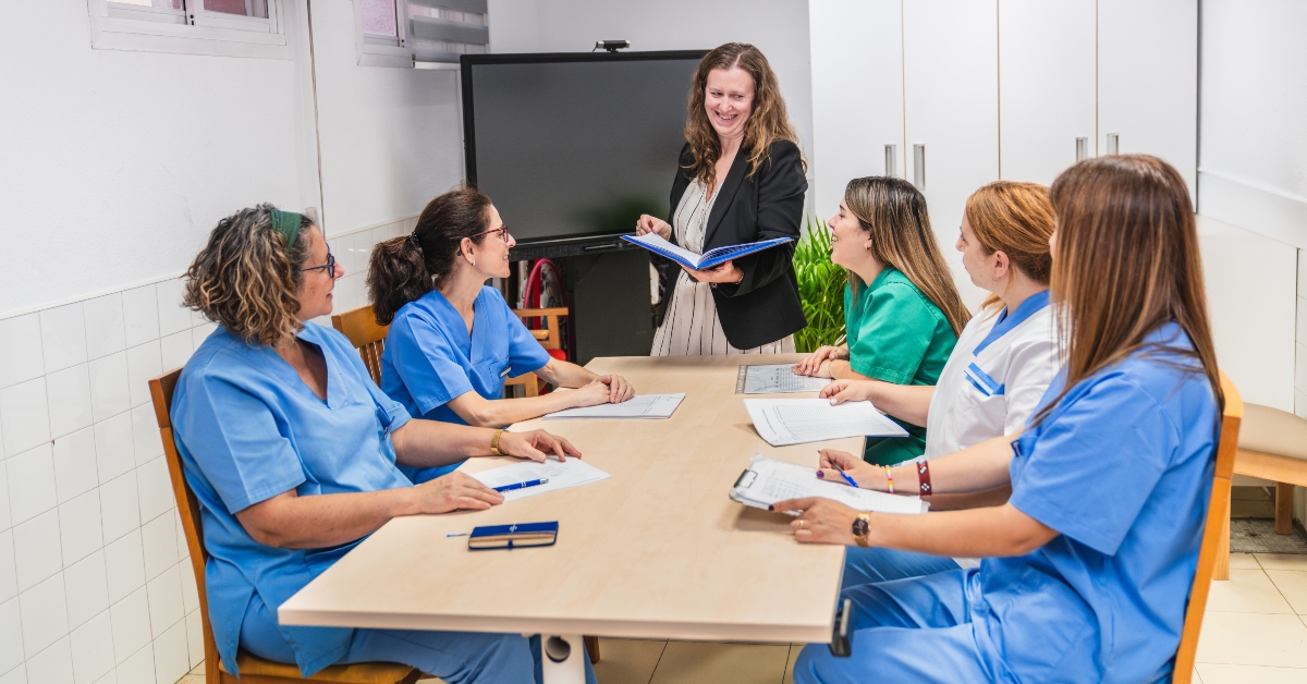 Nurses engaging in team meeting at nursing home