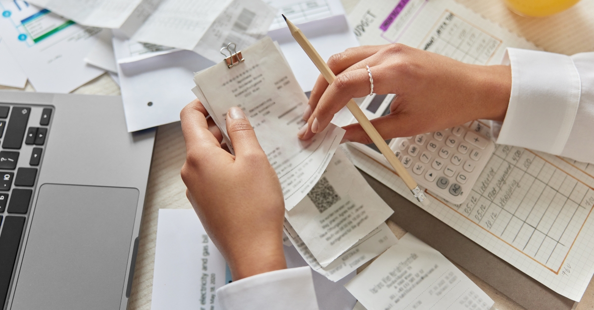 unrecognizable woman holds receipts