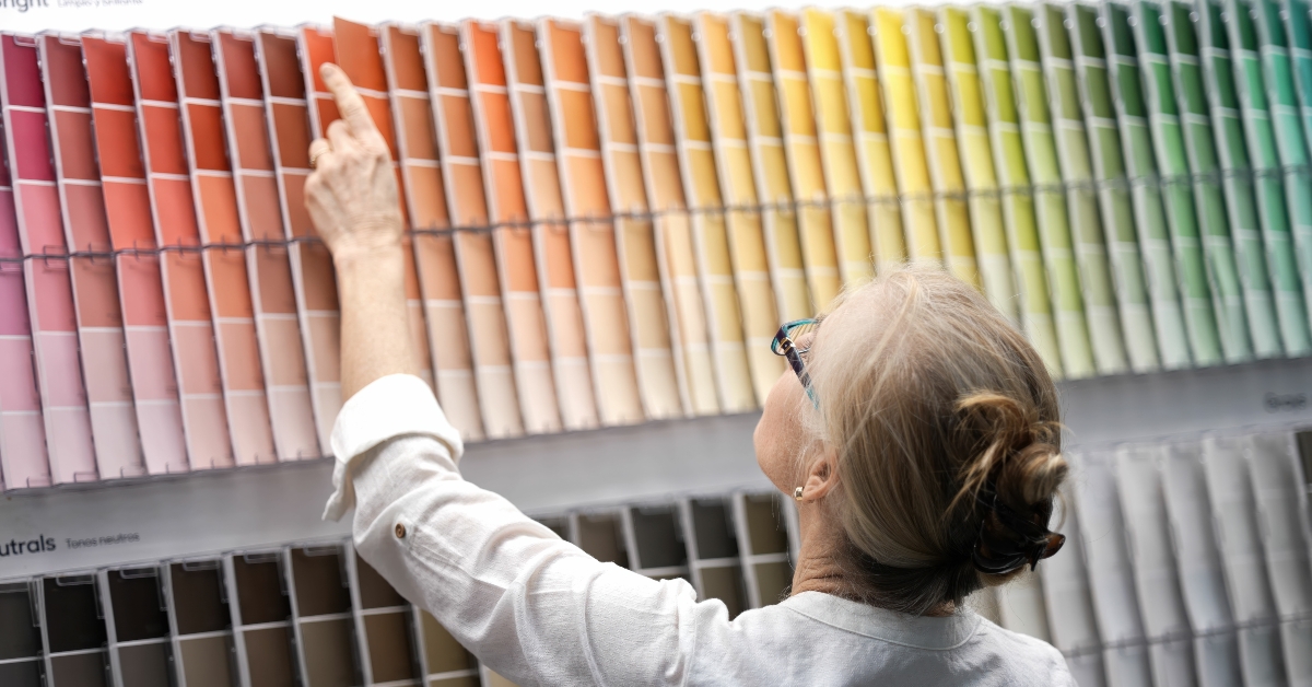woman looking through paint swatches shopping