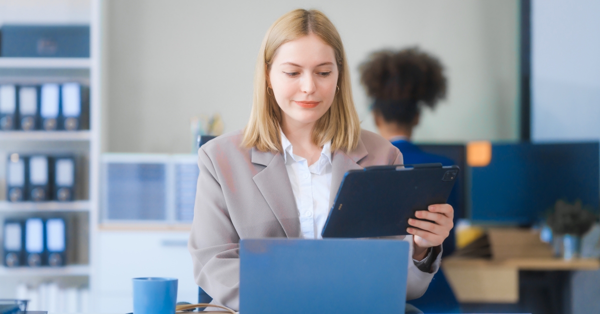  woman in formal suit works diligently