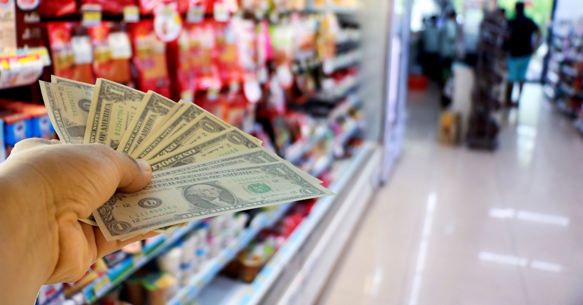 hand holding dollars in shop