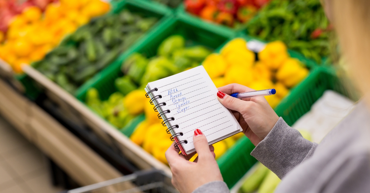 woman with notebook in grocery store