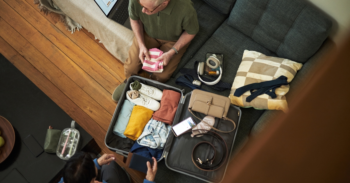 couple diligently packing suitcase