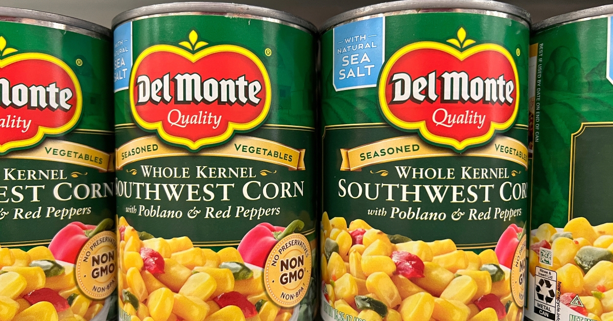 grocery store shelf with cans of del monte brand