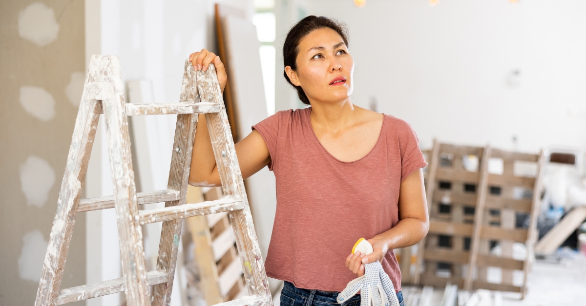 woman standing at stepladder