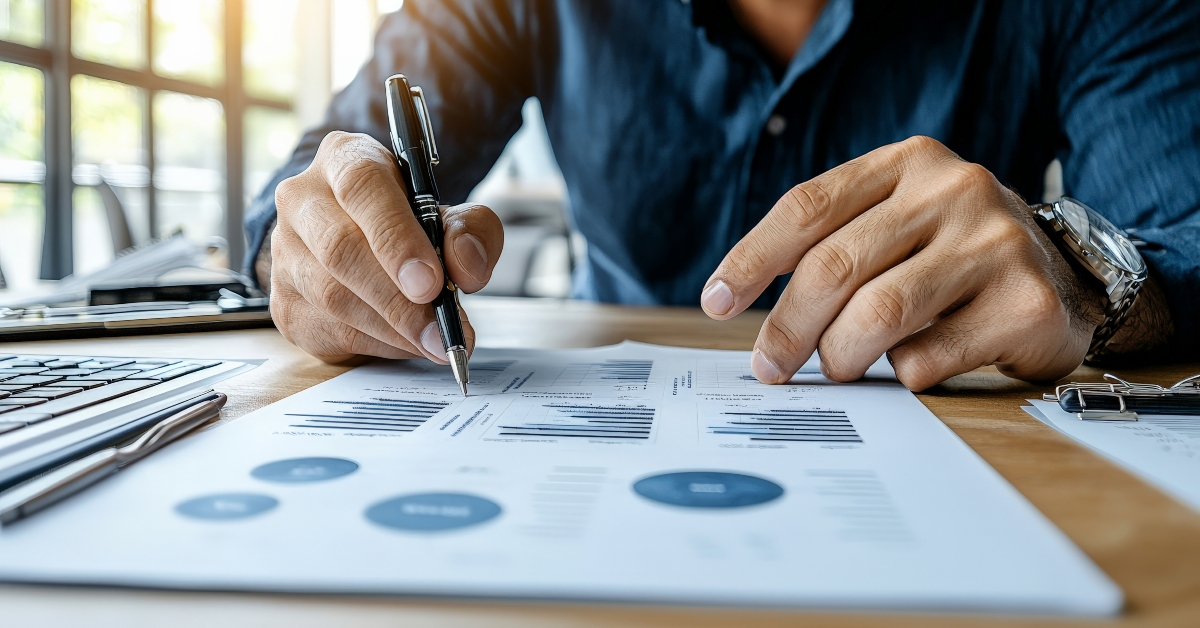 An actuary, pointing at a chart displaying risk