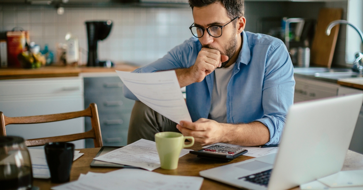 caucasian man going over his bills