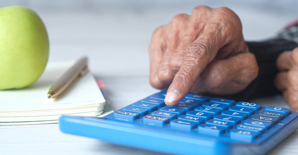 hand using calculator on desk