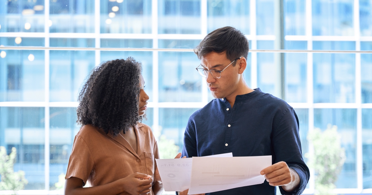 business man and woman discussing project documents