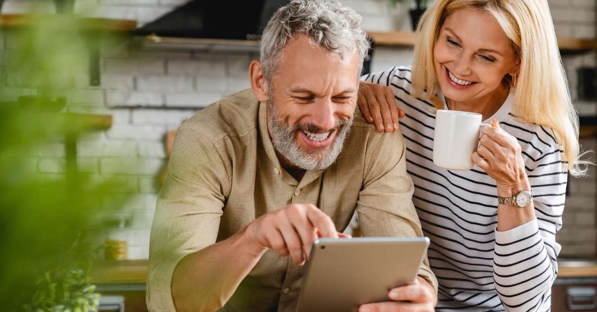 couple using digital tablet in kitchen