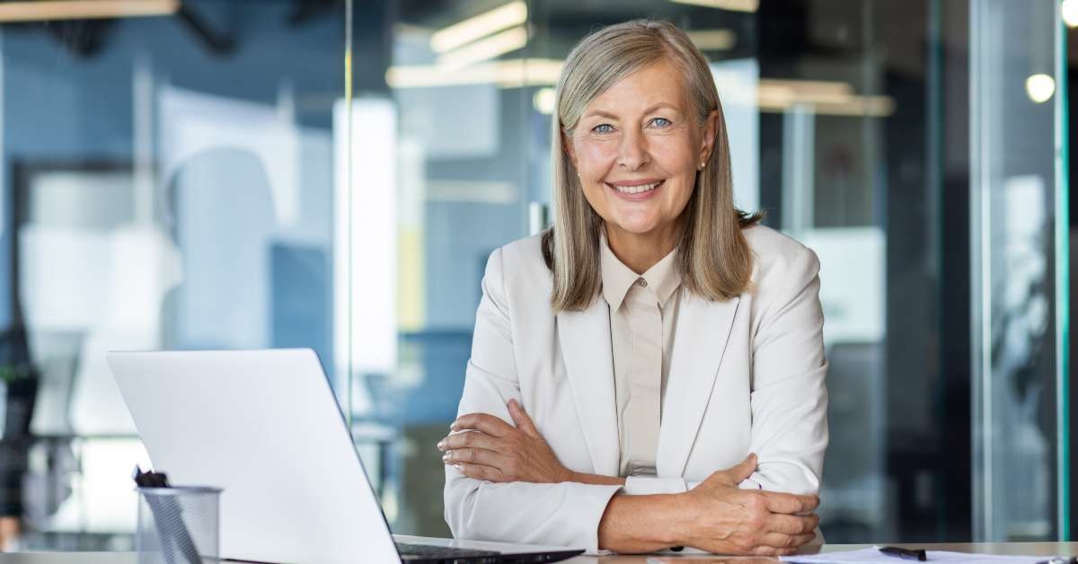female sitting at desk and looking at camera
