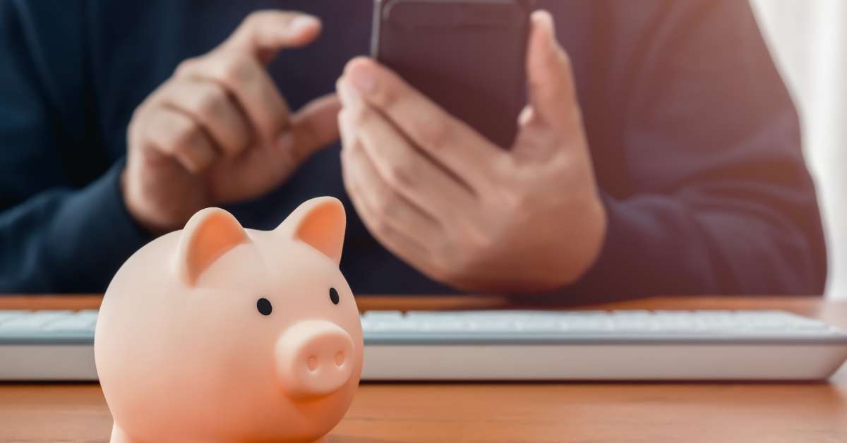 piggy bank on wood table near person
