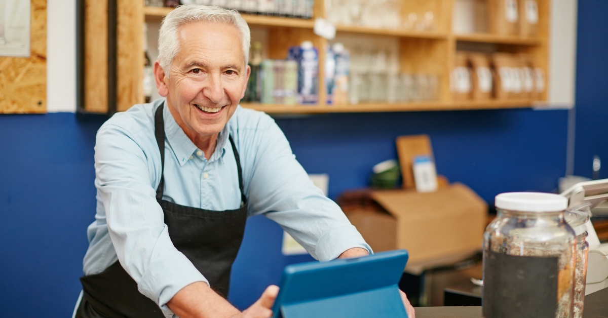 senior man working in a coffee shop
