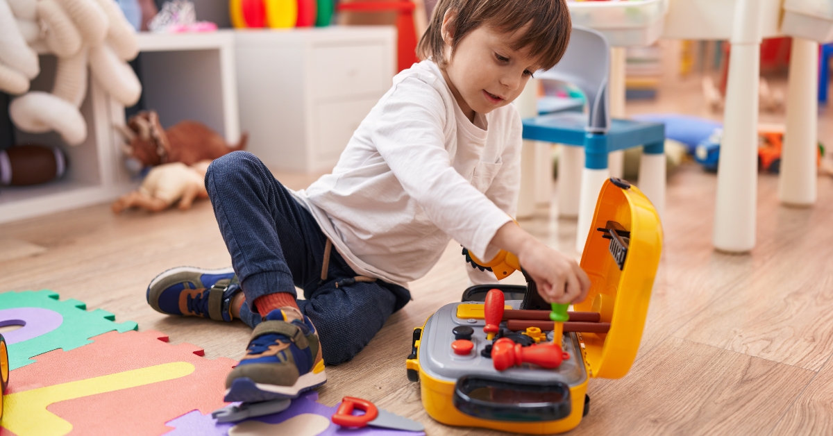 boy playing with tools toy