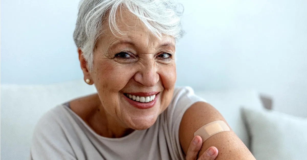 Smiling older woman with a bandage on upper arm