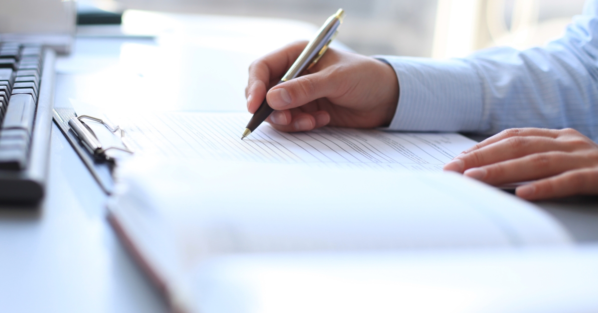 hand pointing at business document 