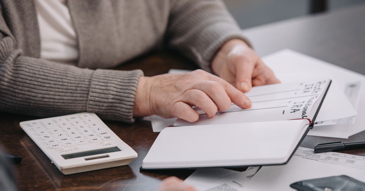senior woman pointing with finger at notebook