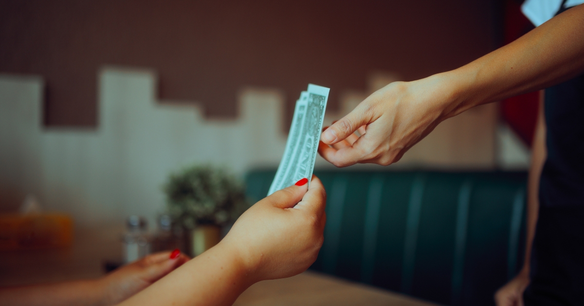 Satisfied Customer Tipping the Waitress in a Restaurant