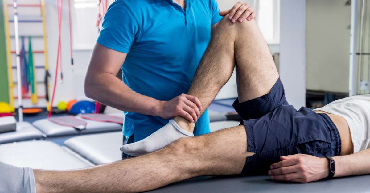 physiotherapist working with patient