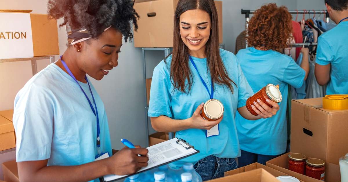 happy volunteer separating donations stuffs