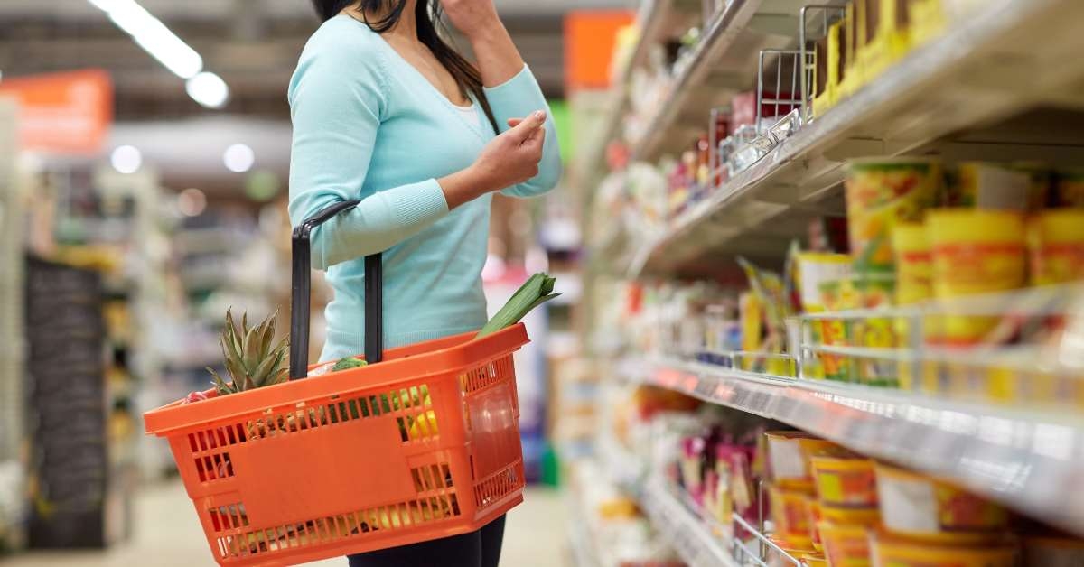 woman with food basket at grocery