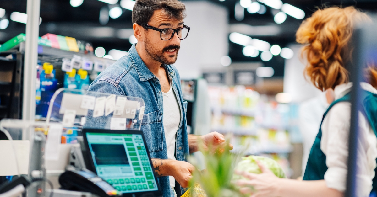 Customer complaining to cashier at supermarket