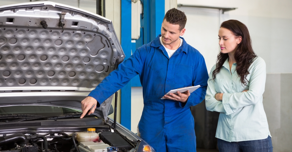 mechanic showing customer the problem