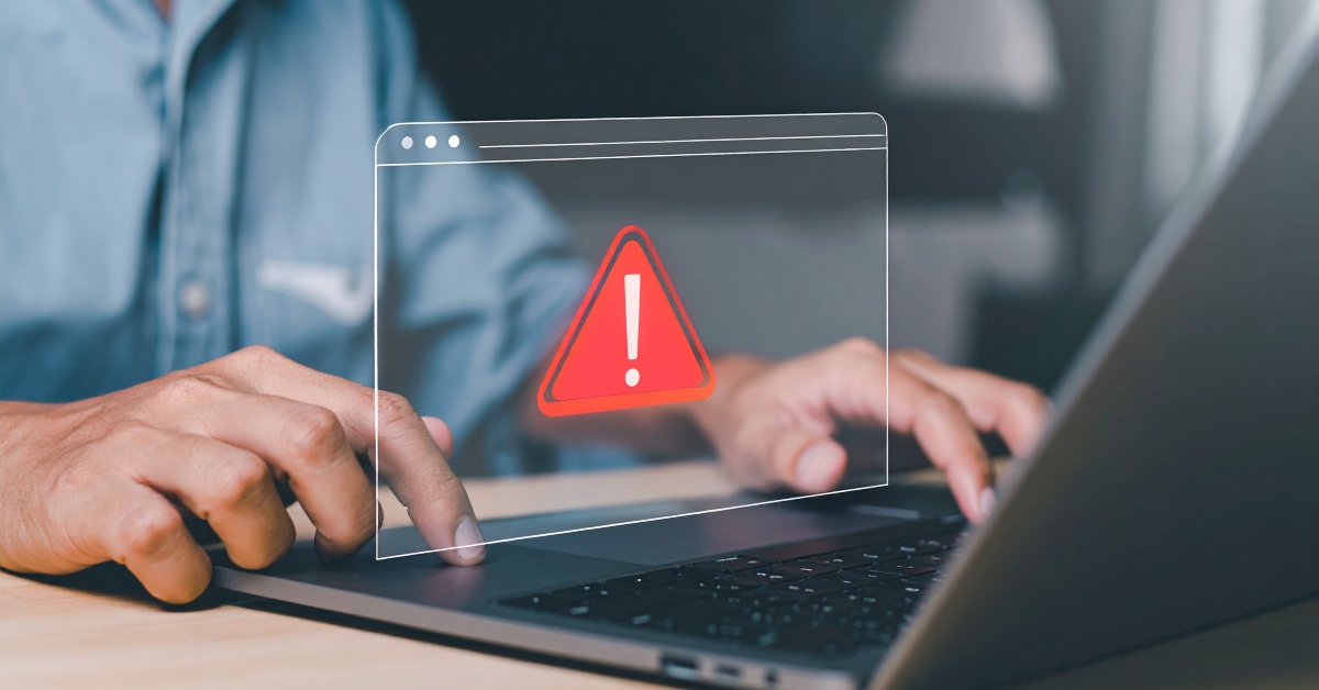 person is working on a laptop and receives a warning