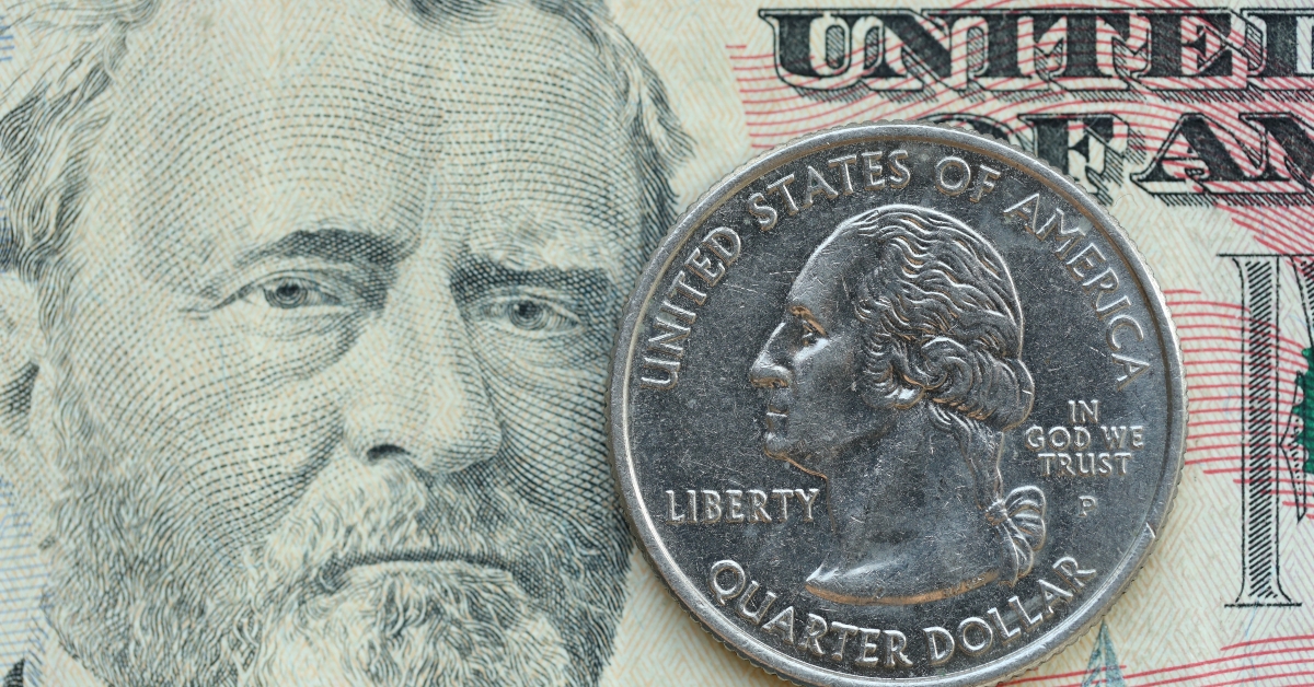 american cent coin on dollar bill