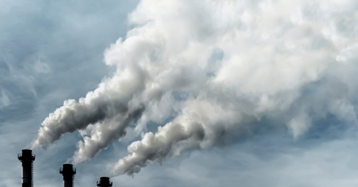 dark chimneys blowing huge billows of smoke