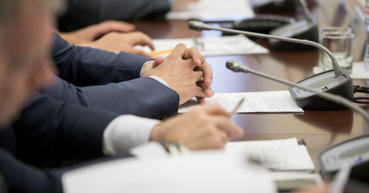 politicians sitting at table during conference