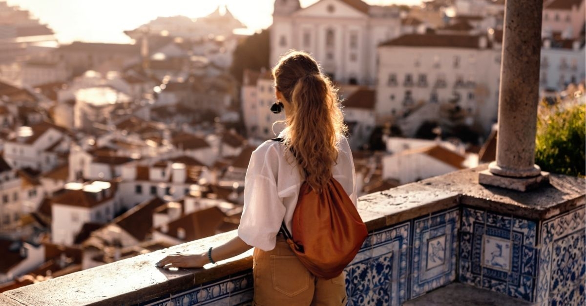 Female tourist looking at old town from balcony 
