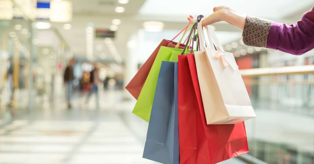 crop hand holding shopping bags